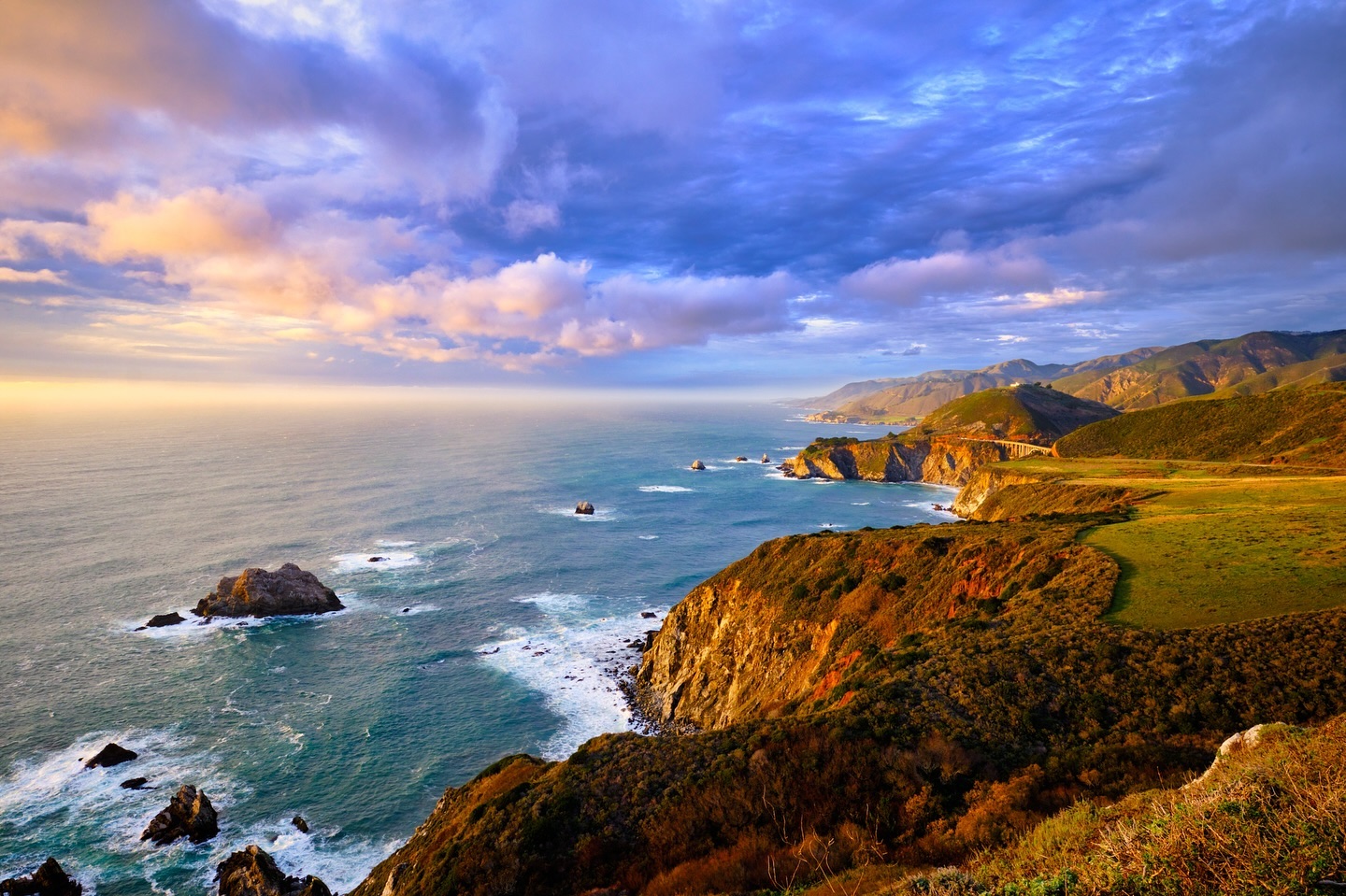 Big Sur coastline at sunset with dramatic clouds