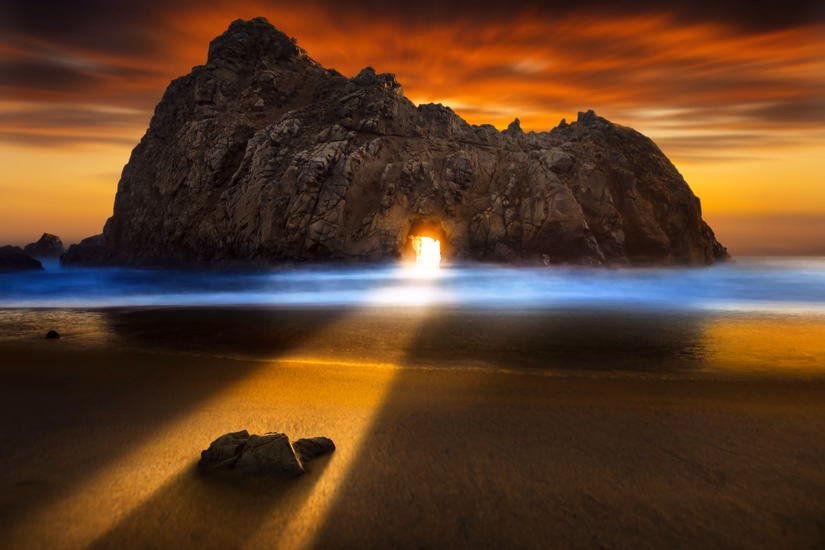 Pfeiffer Beach keyhole arch at sunset with purple sand