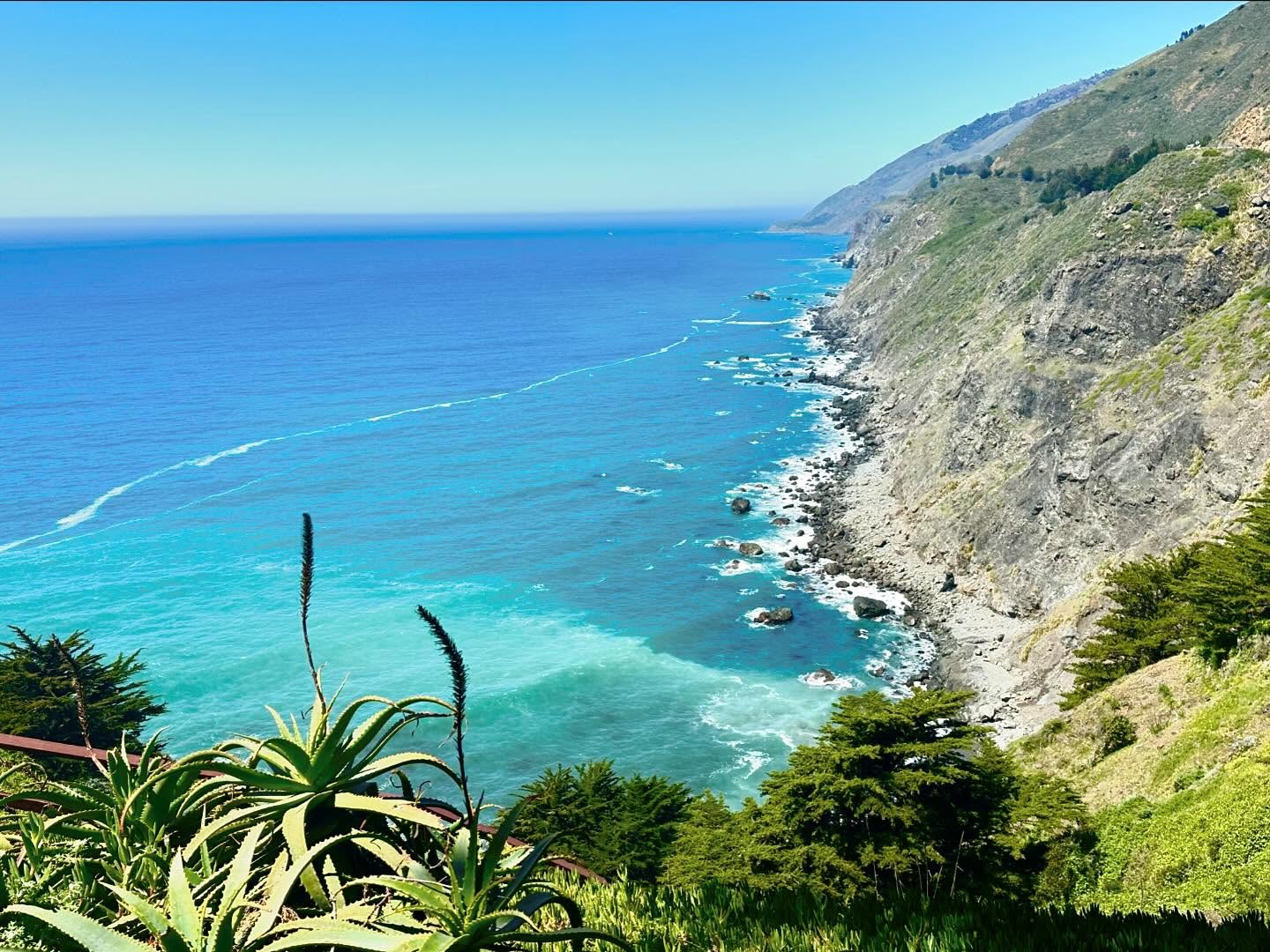 Ragged Point cliffs with building perched on edge