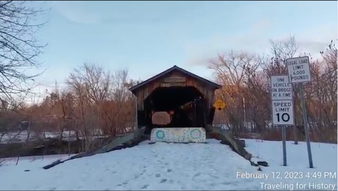 Historic Cambridge Junction Covered Bridge in winter at dusk